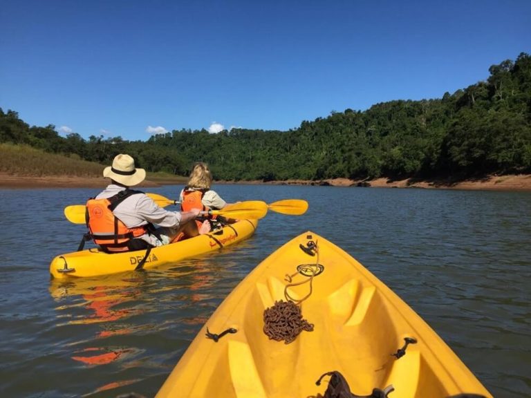 People kayaking on the Paraná River close to the private reserve of La Lorenza Iguazu.